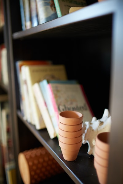 Brown wooden shelf white ceramic cup
